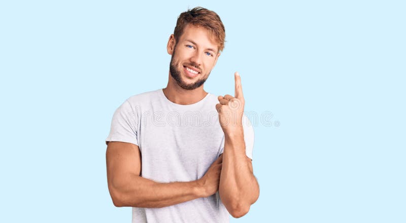 Young caucasian man wearing casual white tshirt with a big smile on face, pointing with hand and finger to the side looking at the camera. Young caucasian man wearing casual white tshirt with a big smile on face, pointing with hand and finger to the side looking at the camera