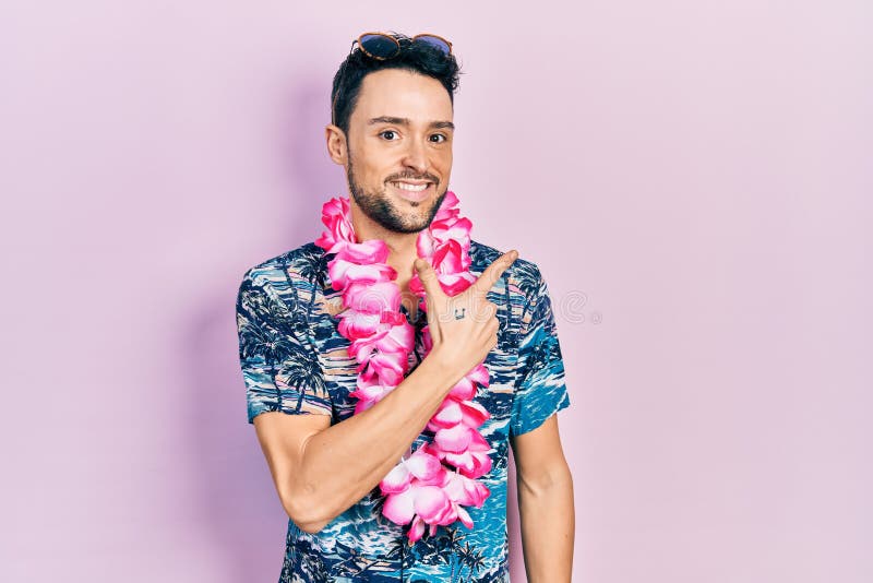 Young hispanic man wearing summer style smiling cheerful pointing with hand and finger up to the side. Young hispanic man wearing summer style smiling cheerful pointing with hand and finger up to the side