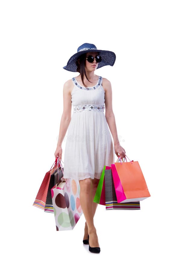 A jovem mulher com os sacos de compras do Natal no branco fotografia de stock royalty free A jovem mulher com os sacos de compras do Natal no branco fotografia de stock royalty free