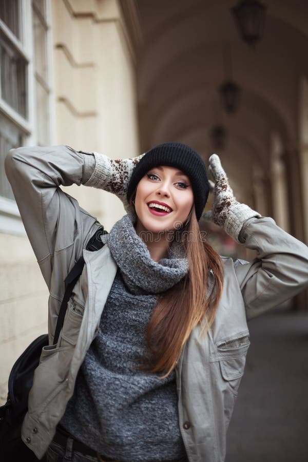 Jovem mulher feliz nos mitenes que sorri e que olha a câmera Fim acima fotografia de stock Jovem mulher feliz nos mitenes que sorri e que olha a câmera Fim acima fotografia de stock