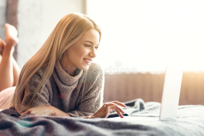Jovem mulher feliz que aprecia o tempo livre em casa imagem de stock royalty free Jovem mulher feliz que aprecia o tempo livre em casa imagem de stock royalty free