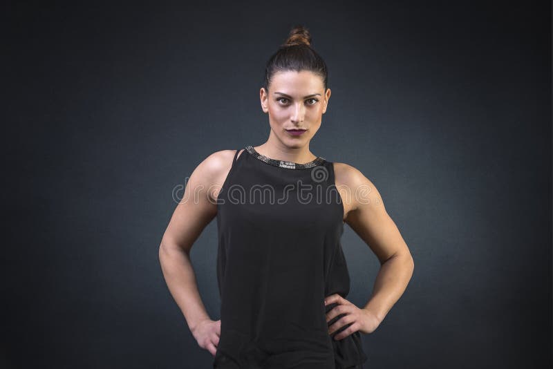Jovem mulher muscular e atrativa, mostrando fora a sua construção forte o corpo muscular vestido por uma noite para fora fotos de stock royalty free Jovem mulher muscular e atrativa, mostrando fora a sua construção forte o corpo muscular vestido por uma noite para fora fotos de stock royalty free