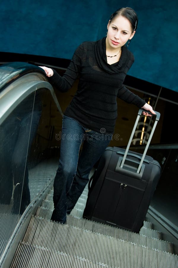 Jovem mulher na escada rolante fotografia de stock