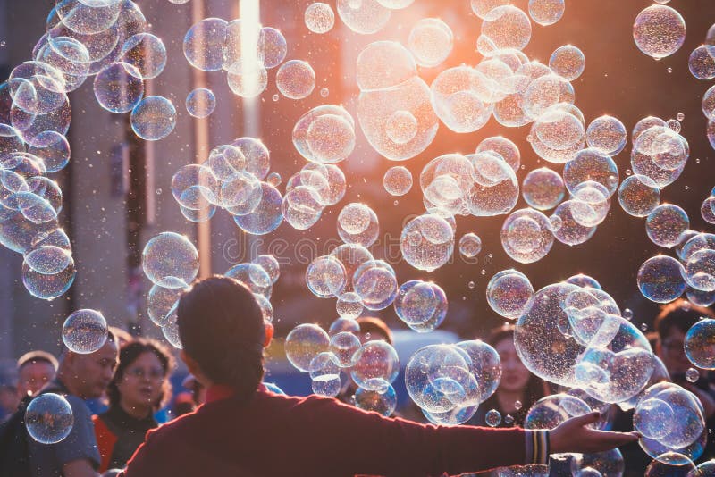 Prague, Czech Republic, September 29, 2017: Unidentified young woman catching the soap bubbles in Old Town Square in Prague, Czech Republic. Prague, Czech Republic, September 29, 2017: Unidentified young woman catching the soap bubbles in Old Town Square in Prague, Czech Republic