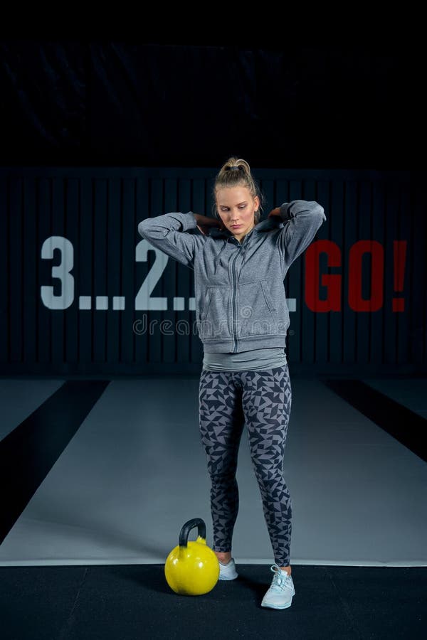 Jovem mulher que exercita com kettlebells no gym Ocupas que squatting o gym da aptidão do balanço WOD Exercício da mulher da apti fotos de stock Jovem mulher que exercita com kettlebells no gym Ocupas que squatting o gym da aptidão do balanço WOD Exercício da mulher da apti fotos de stock