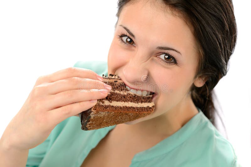 Jovem mulher ávida que come o bolo saboroso