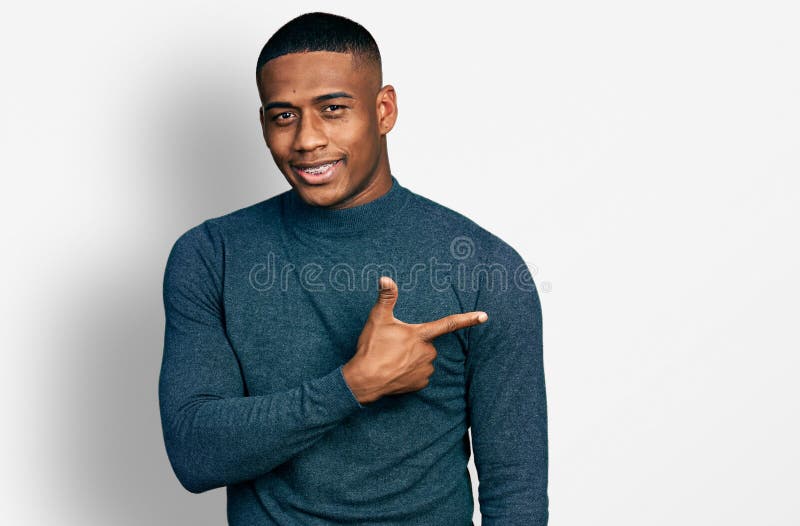 Young black man wearing casual sweater smiling cheerful pointing with hand and finger up to the side. Young black man wearing casual sweater smiling cheerful pointing with hand and finger up to the side