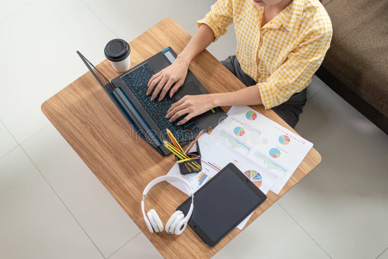 Beautiful young Asian businesswoman working with laptop at her house, work from home, business concept. Beautiful young Asian businesswoman working with laptop at her house, work from home, business concept