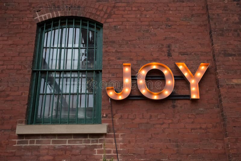 JOY Light Bulb Sign on Wall royalty free stock photography JOY Light Bulb Sign on Wall royalty free stock photography