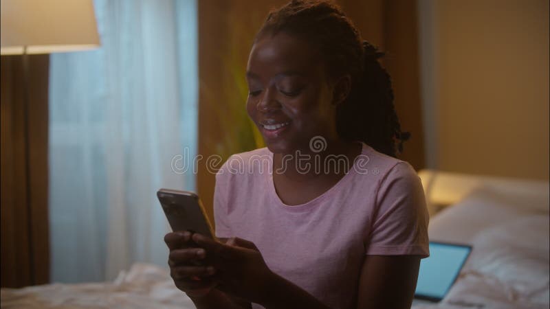 Joyeux sourire afro-américain femme femme femme femme femme cliente client tenant un téléphone portable taper clips vidéos