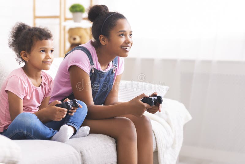 Two sisters play games - a Royalty Free Stock Photo from Photocase