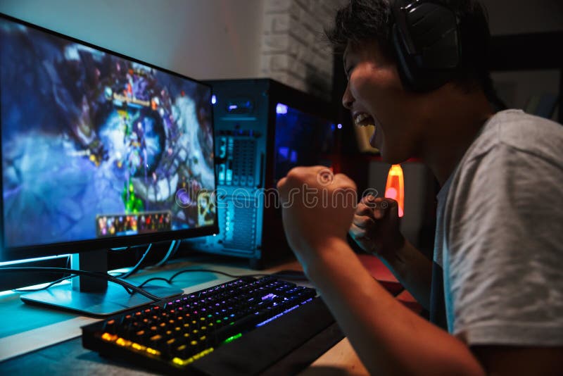 Boy play game on gaming PC online. Stock Photo