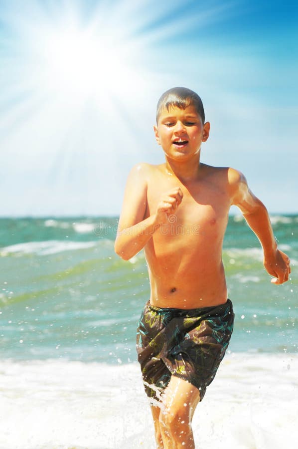 Joyful boy on an ocean coast