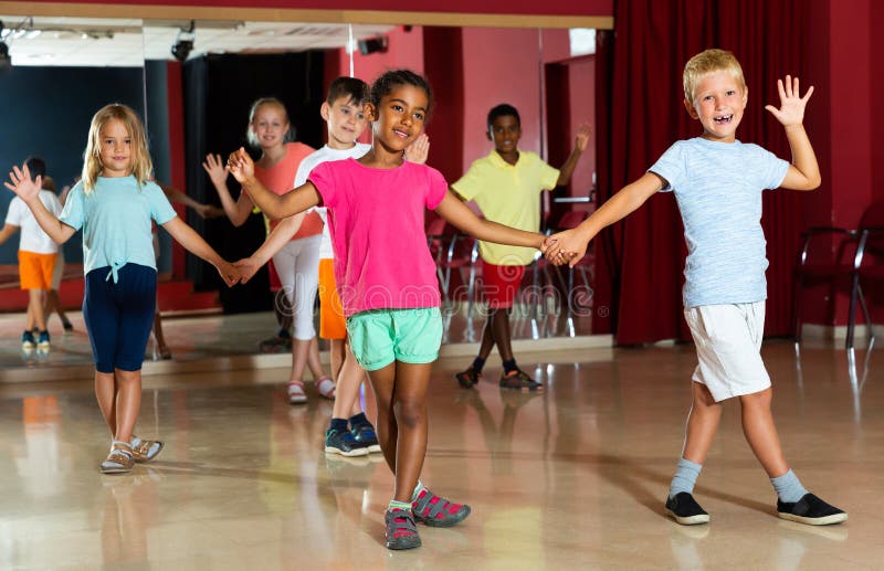 Joyful children trying dancing partner dance