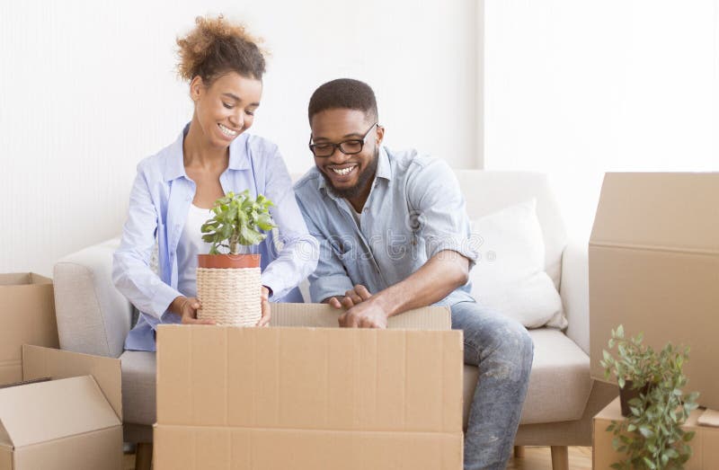 joyful-couple-moving-house-packing-plant