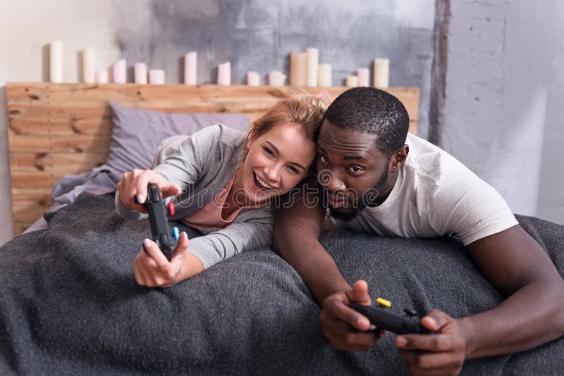 Joyful Couple Playing Video Games in Bed Stock Photo Image of