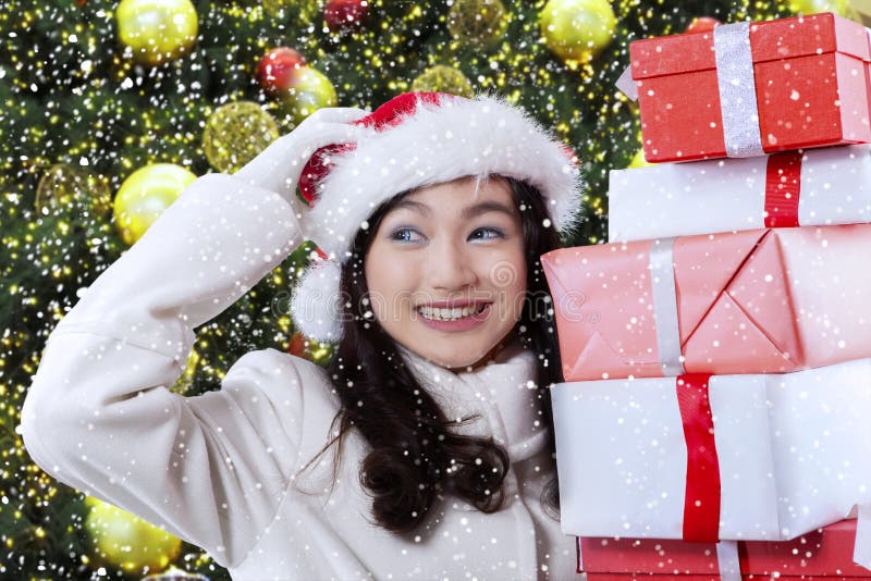 Joyful girl holding christmas presents
