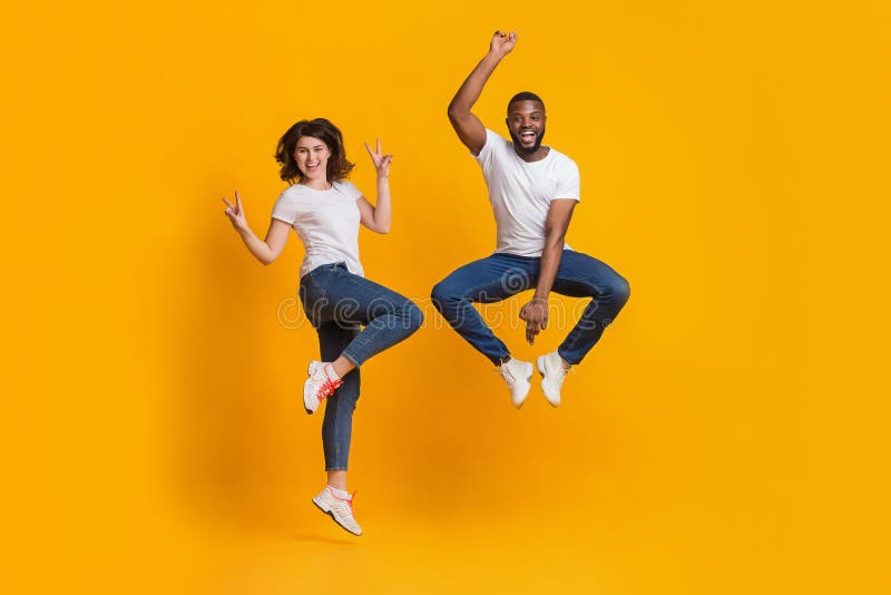 Happy Crazy Funny Couple In Summer Casual Clothes Having Fun Outdoors In  The City Posing To Camera Laughing And Raising Their Legs In Sneakers Up  Stock Photo - Download Image Now - iStock