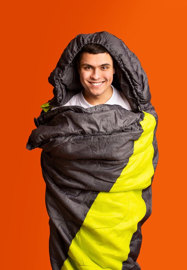 Joyful Guy Hiker Wrapped in Colorful Sleeping Bag Stock Photo Image