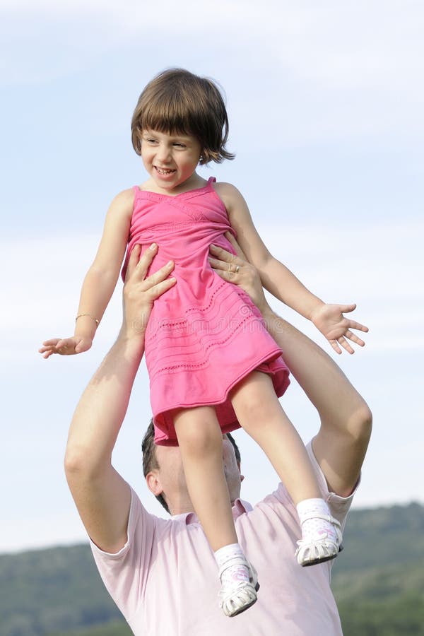 Joyful kid playing with her dad stock photography