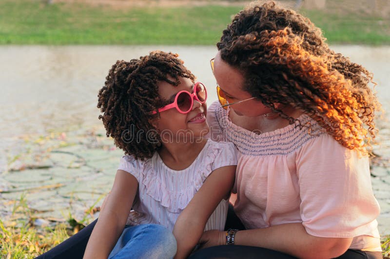 Joyful Mother and Daughter Laughing Outdoors on Summer Vacation Stock