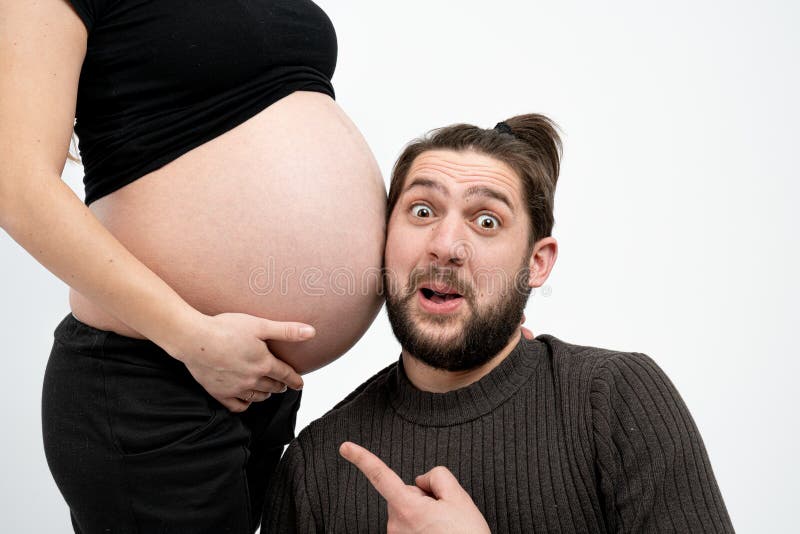 Joyful, Playful Happy Bearded Man in Casual Clothes is Listening with Funny  Face To His Pregnant Wife`s Tummy, Isolated Stock Image - Image of adult,  home: 170137331