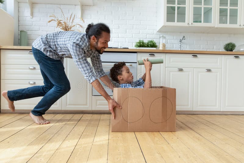 Joyful bonding African American family having fun at home. royalty free stock photos