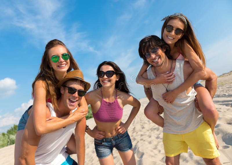 Joyful smiling friends having fun on the beach royalty free stock photo Joyful smiling friends having fun on the beach royalty free stock photo