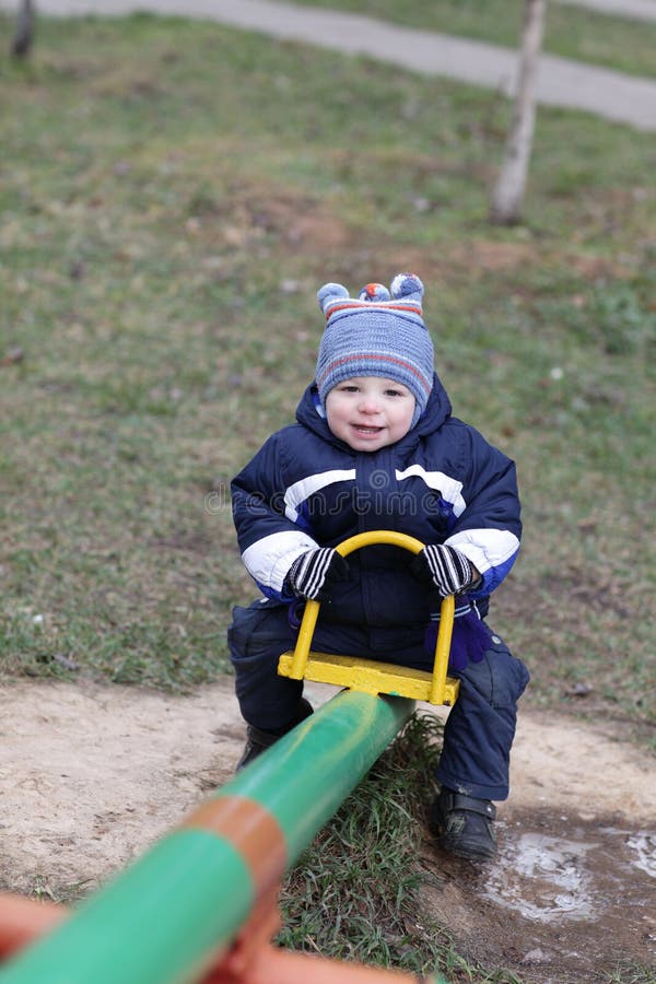 Joyful toddler on seesaw royalty free stock images