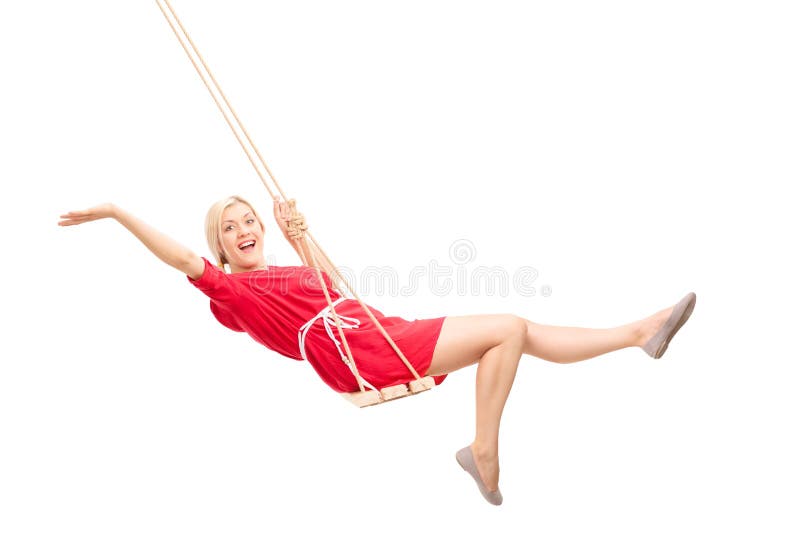 Joyful woman swinging on a swing