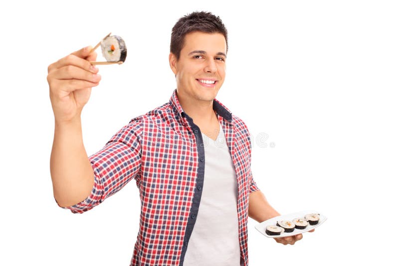 Joyful young man holding a piece of sushi