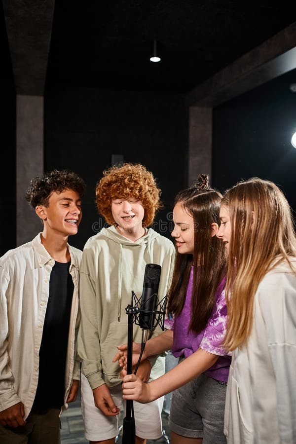 joyous talented teenage boys and girls singing together and smiling in studio, musical group, stock photo. joyous talented teenage boys and girls singing together and smiling in studio, musical group, stock photo