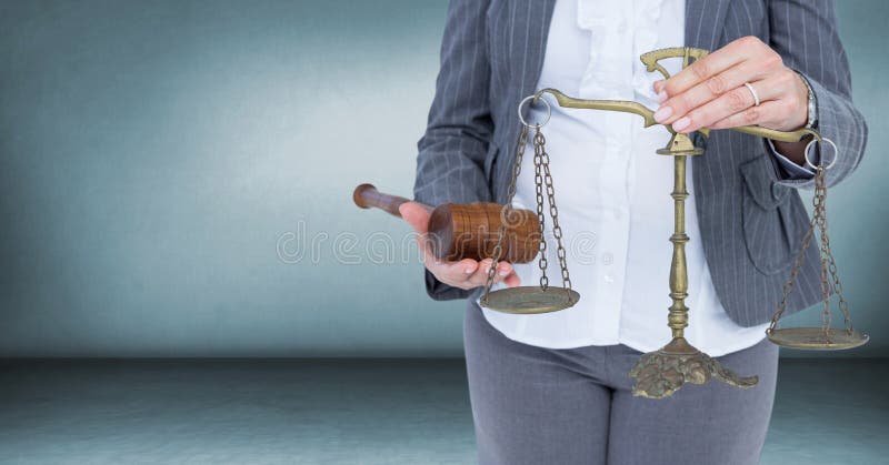 Judge with balance scale and hammer in front of blue room royalty free stock photography