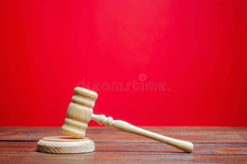 Judge`s hammer on a red background. The judicial system. Norms, rules and laws. Conflict resolution in court. Court case, settlin. G disputes. Protection of stock photography Judge`s hammer on a red background. The judicial system. Norms, rules and laws. Conflict resolution in court. Court case, settlin. G disputes. Protection of stock photography