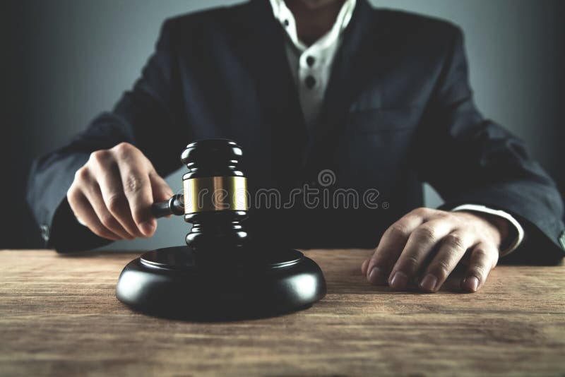 Judge Striking Gavel on Sounding Block. Law and Justice Concept Stock
