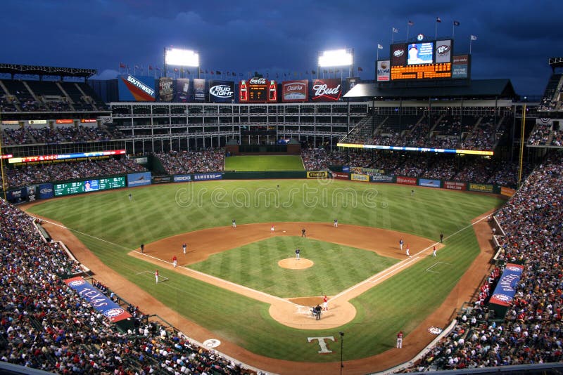 There was a big crowd at the recent Rangers and Rays baseball game. There were big clouds in the night sky threatening the game with rain. There was a big crowd at the recent Rangers and Rays baseball game. There were big clouds in the night sky threatening the game with rain.