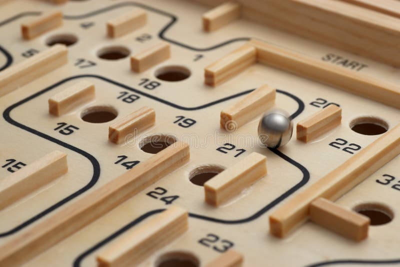 A challenging wooden maze game where a ball is manouvered to miss the holes. A challenging wooden maze game where a ball is manouvered to miss the holes.