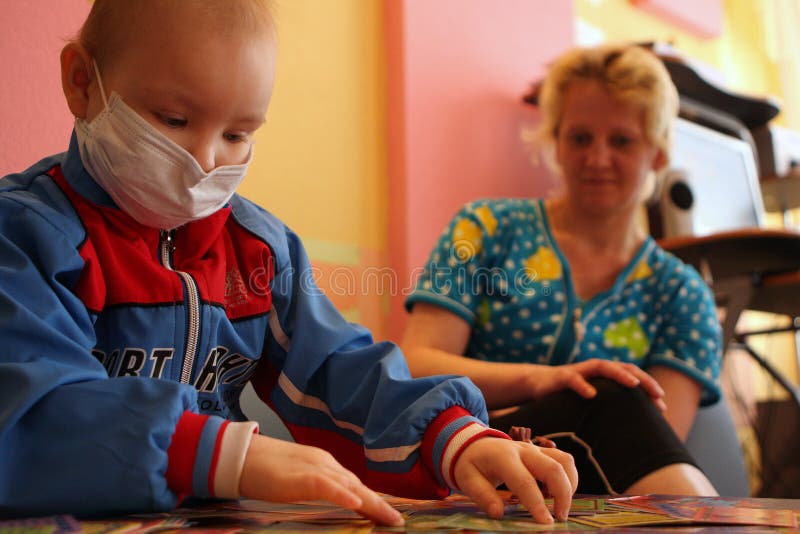 Tomsk, Russia - June 25, 2009: Unidentified child plays in children's playing room in pediatric oncohematological department on Tomsk Regional Clinical Hospital. The Department of Pediatric Oncology and Hematology. Tomsk Regional Clinical Hospital. Ill children live here together with their mothers. Leukemia (a blood cancer), anemia, hemophilia â€“ these diseases rank second in the statistics of mortality of children under the age of 14. First rank is the accidents (injuries and poisoning). In case of blood cancer the most important thing is to diagnose it in time. If the illness was detected early and the treatment was picked up correctly, the probability of treatment or transition in a condition of long remission at children makes 80-90 percent. In Russia during the last years the survival rate at a blood cancer has grown with 4 to 80 percent. Tomsk, Russia - June 25, 2009: Unidentified child plays in children's playing room in pediatric oncohematological department on Tomsk Regional Clinical Hospital. The Department of Pediatric Oncology and Hematology. Tomsk Regional Clinical Hospital. Ill children live here together with their mothers. Leukemia (a blood cancer), anemia, hemophilia â€“ these diseases rank second in the statistics of mortality of children under the age of 14. First rank is the accidents (injuries and poisoning). In case of blood cancer the most important thing is to diagnose it in time. If the illness was detected early and the treatment was picked up correctly, the probability of treatment or transition in a condition of long remission at children makes 80-90 percent. In Russia during the last years the survival rate at a blood cancer has grown with 4 to 80 percent.
