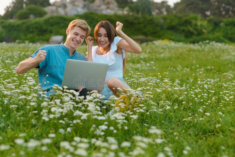 Jugando a juegos al aire libre con un ordenador portátil fotos de archivo Jugando a juegos al aire libre con un ordenador portátil fotos de archivo