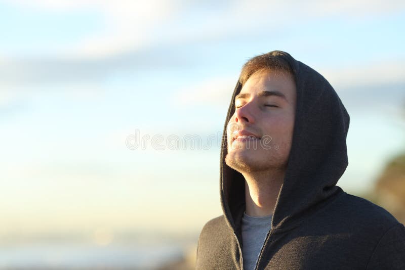 Happy teenage man breathing deep fresh air on the beach. Happy teenage man breathing deep fresh air on the beach