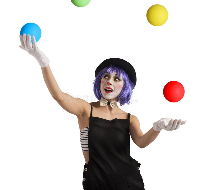 Concentrated juggler clown playing with colorful ball