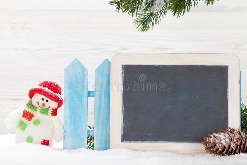 Juguete y pizarra del muñeco de nieve de la Navidad imagen de archivo Juguete y pizarra del muñeco de nieve de la Navidad imagen de archivo