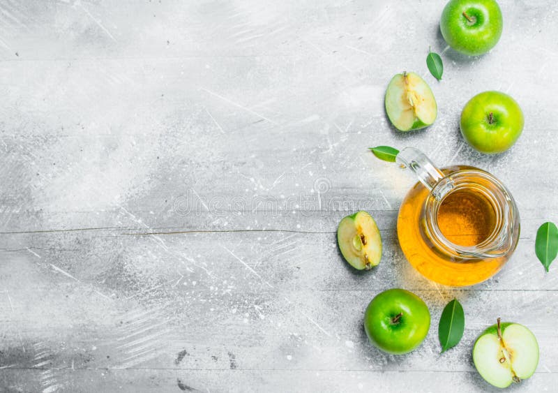 Juice and Fresh Apples in a Glass Jar with Slices of Apples Stock Image