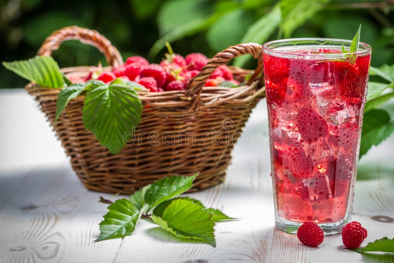 Juice from freshly harvested raspberries served with ice on old table. Raspberry basket stock images, royalty-free photos and pictures