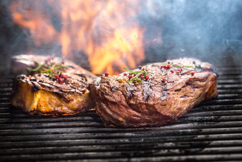 Juicy Beef Rib Eye Steaks on the Grill with Rosemary Salt Spices and