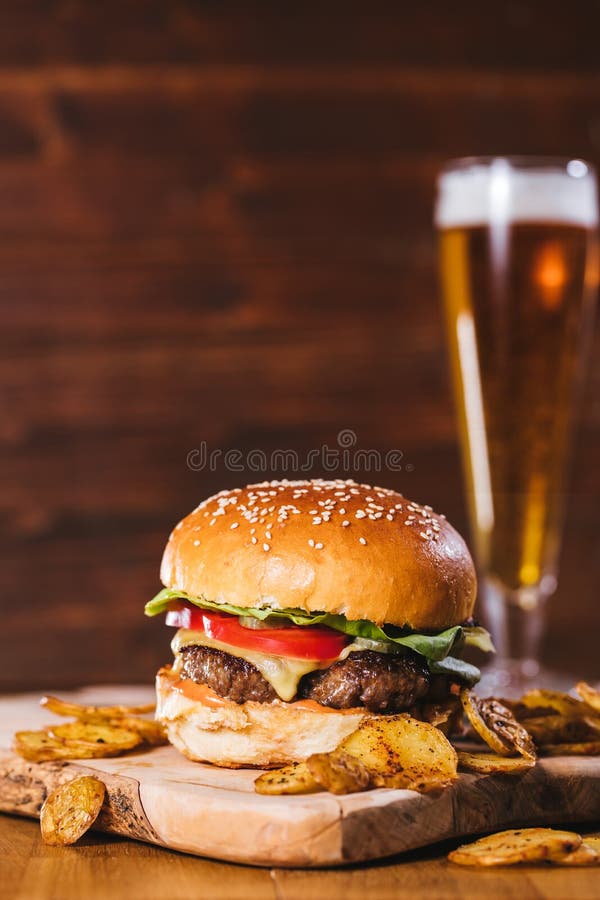 Juicy Burger with potato wedges and beer