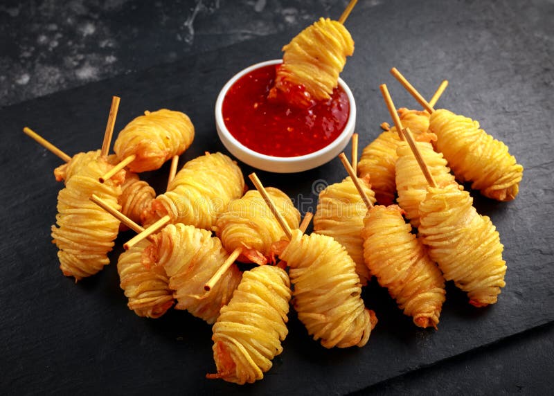 Juicy king prawns wrapped in little spirals of crisp, golden potato on skewers served with sweet chillie sauce. stock photography Juicy king prawns wrapped in little spirals of crisp, golden potato on skewers served with sweet chillie sauce. stock photography
