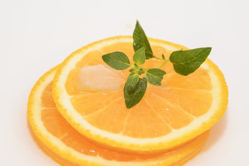 Juicy oranges slice with ice and mint