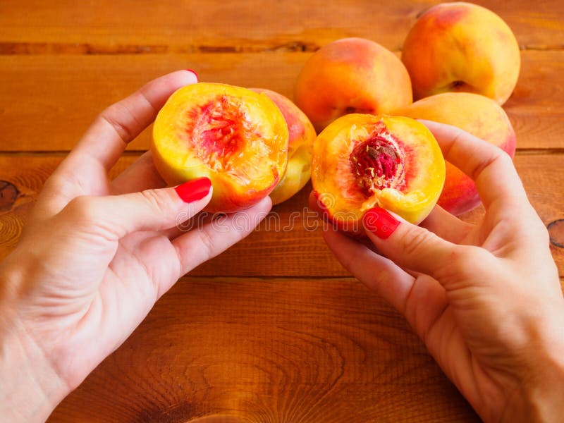 Juicy peach in woman's hands.