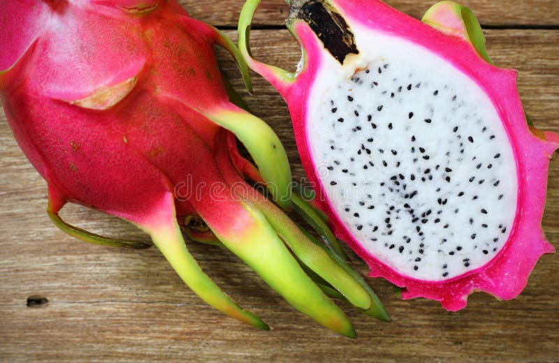 Juicy pink pitaya on wooden table